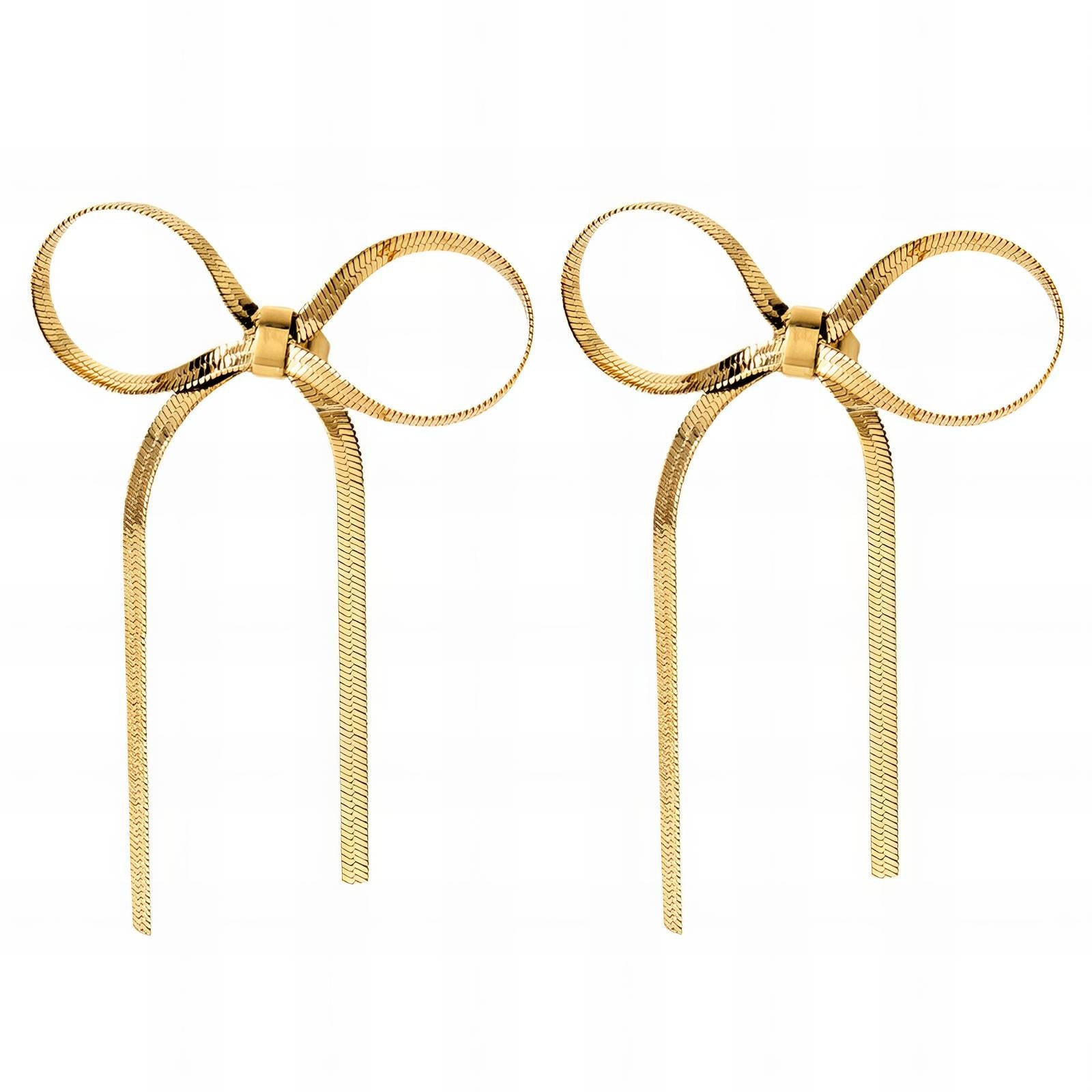 Pair of gold bow-shaped earrings on a white background