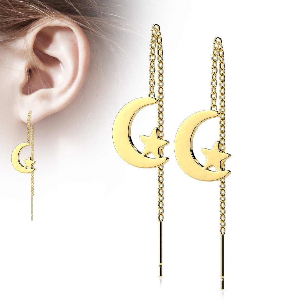 Gold moon and star threader earrings worn on an ear against a white background