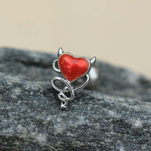 Devil Heart Cartilage Bar 16G – Red Enamel Winged Heart with Stainless Steel Tragus Bar on a stone surface