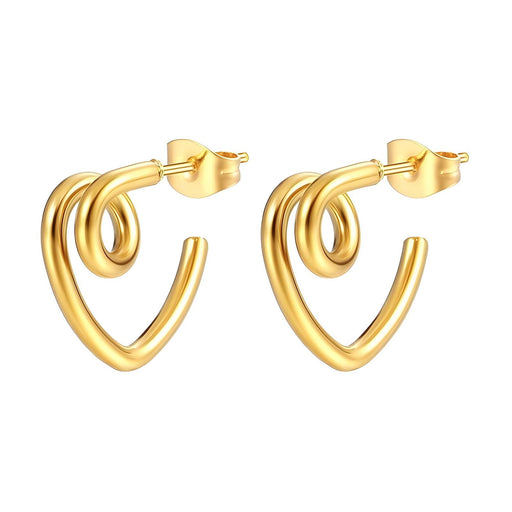 Gold hoop earrings on a textured surface