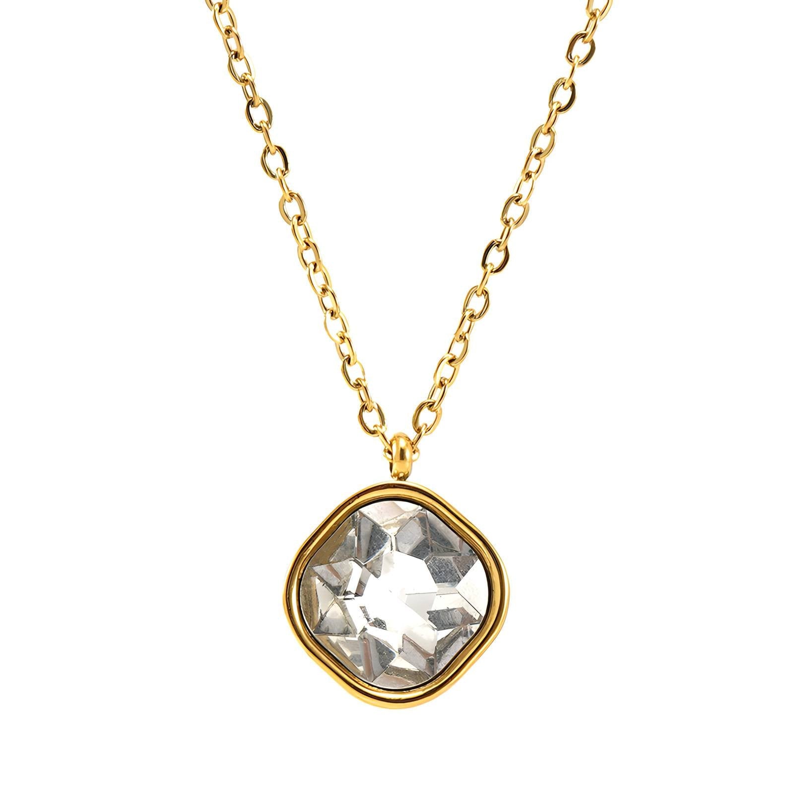 Gold necklace with a clear gemstone pendant on a white background