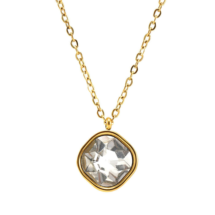 Gold necklace with a clear gemstone pendant on a white background