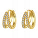 Gold hoop earrings with clear gemstones on a white background