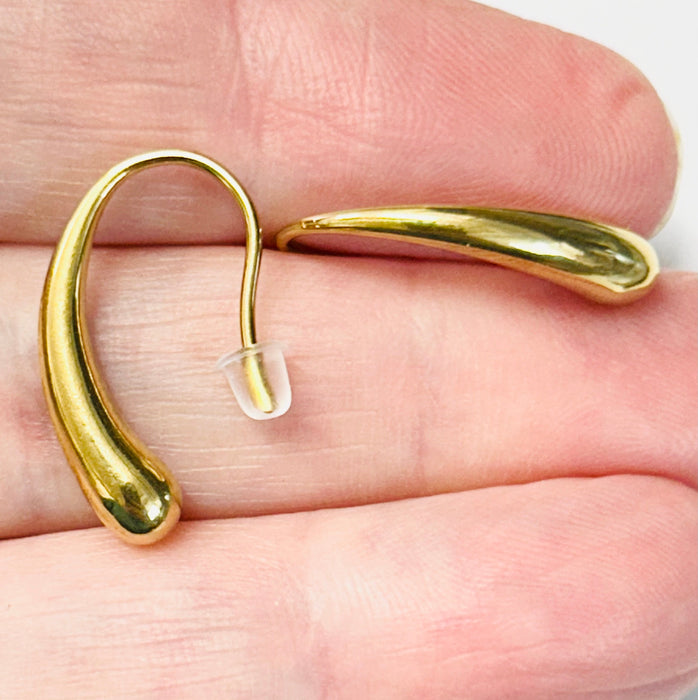 gold drop earrings on hand