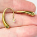 gold drop earrings on hand