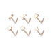 Set of rose gold nose rings with various shapes on a white background