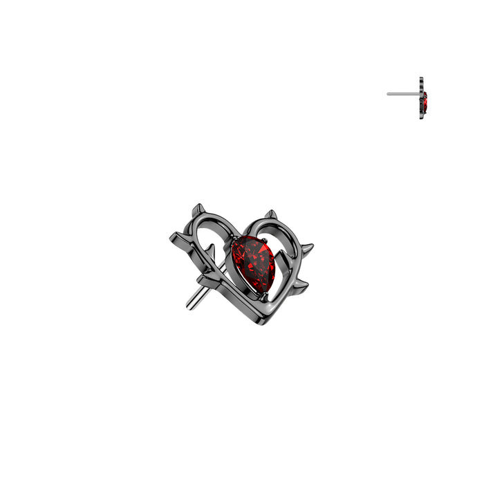 Heart-shaped jewelry piece with a red gemstone on a white background