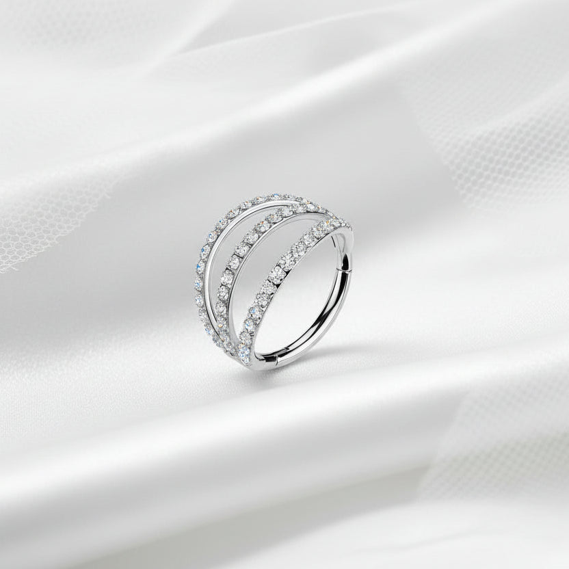Silver ring with diamonds on a white fabric background