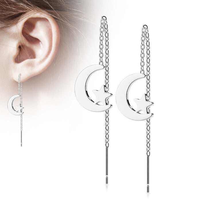 Silver moon-shaped earrings with chain details worn by a person.