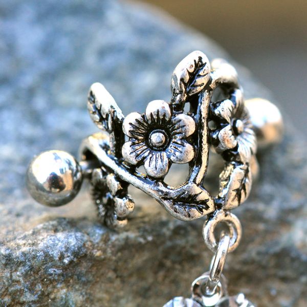Flower Vine Cartilage Cuff – Antique Floral 316L Stainless Steel Ear Cuff with Clear CZ Drops sideways on rock display