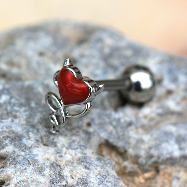 Devil Heart Cartilage Bar 16G – Red Enamel Winged Heart with Stainless Steel Tragus Bar on a stone surface
